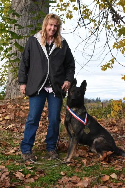 2017 RVSC fall Schutzhund trial — a handler posing with a working dog after field exercises