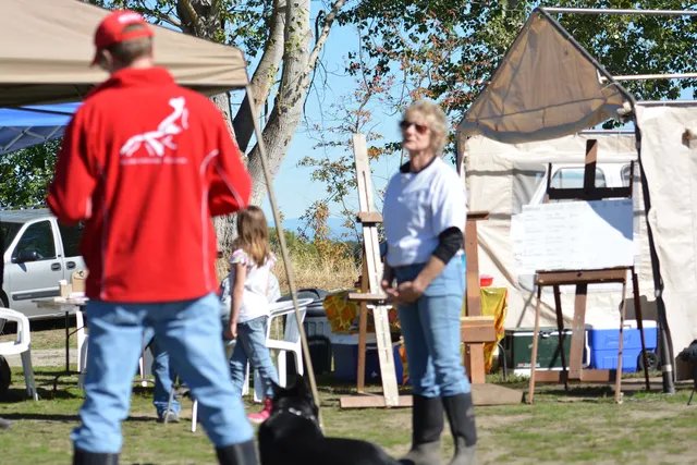October 5–6, 2013 RVSC Affiliation Trial on October 5–6, 2013 — a handler maintaining control and attention with a working dog on the trial field — photo 52