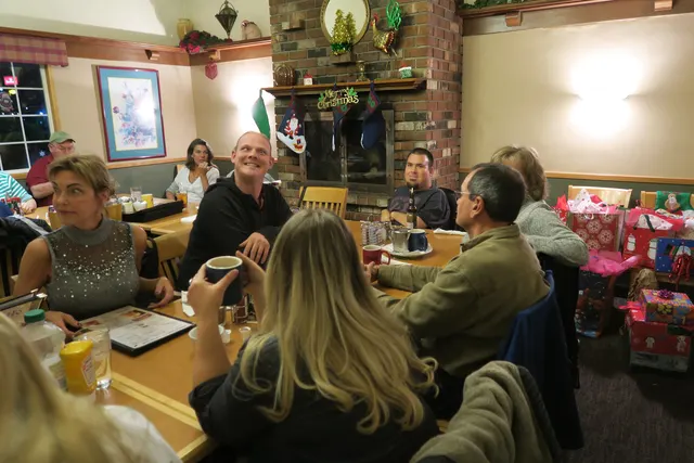 2016 Club Christmas Party on December 17, 2016 — members gathered around the table during the Christmas party — photo 04