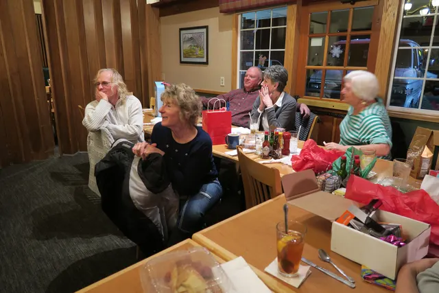 2016 Club Christmas Party on December 17, 2016 — club members seated near holiday gifts during the party — photo 12