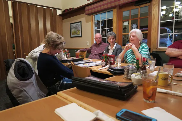 2016 Club Christmas Party on December 17, 2016 — club members seated together at the holiday dinner table — photo 01