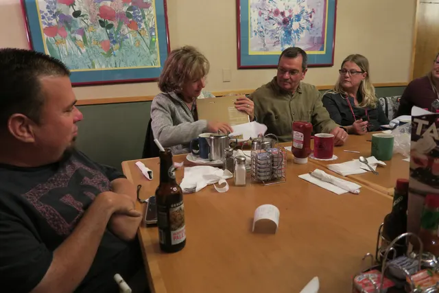 2016 Club Christmas Party on December 17, 2016 — club members talking together at the dinner table — photo 15