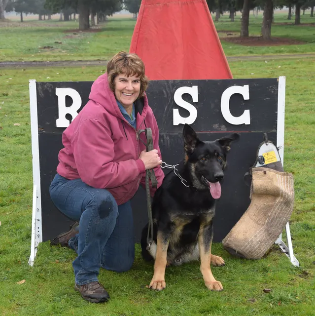 March 22, 2014 RVSC Club Training — a club member posing with a working dog at the RVSC field — photo 06