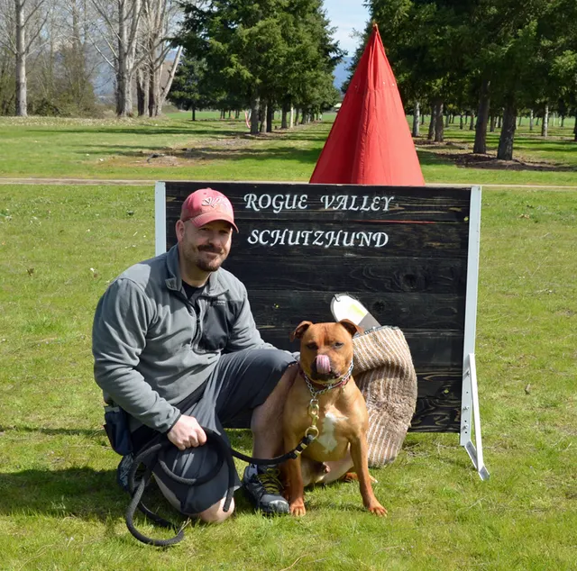 March 24, 2013 RVSC Club Training on March 24, 2013 — a club member kneeling beside a working dog for a historical club portrait — photo 04
