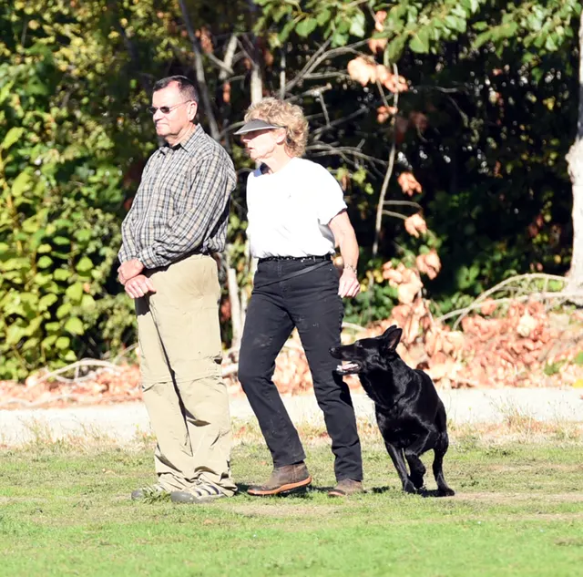 October 2016 Schutzhund Trial on October 8, 2016 — a judge accompanying a handler and dog during trial evaluation — photo 07