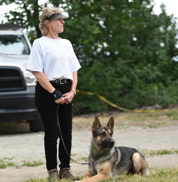 2016 RVSC Spring Schutzhund Trial — a handler maintaining control with a working dog on the trial field — photo 03